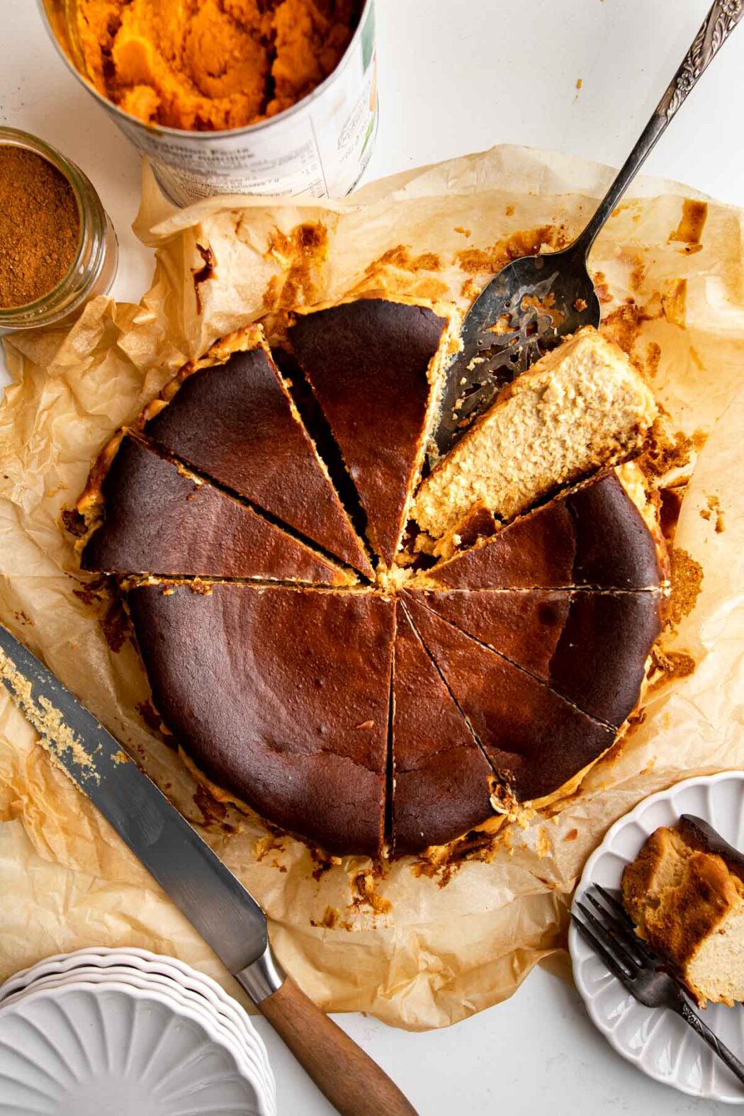 Sliced pumpkin basque cheesecake on parchment paper.